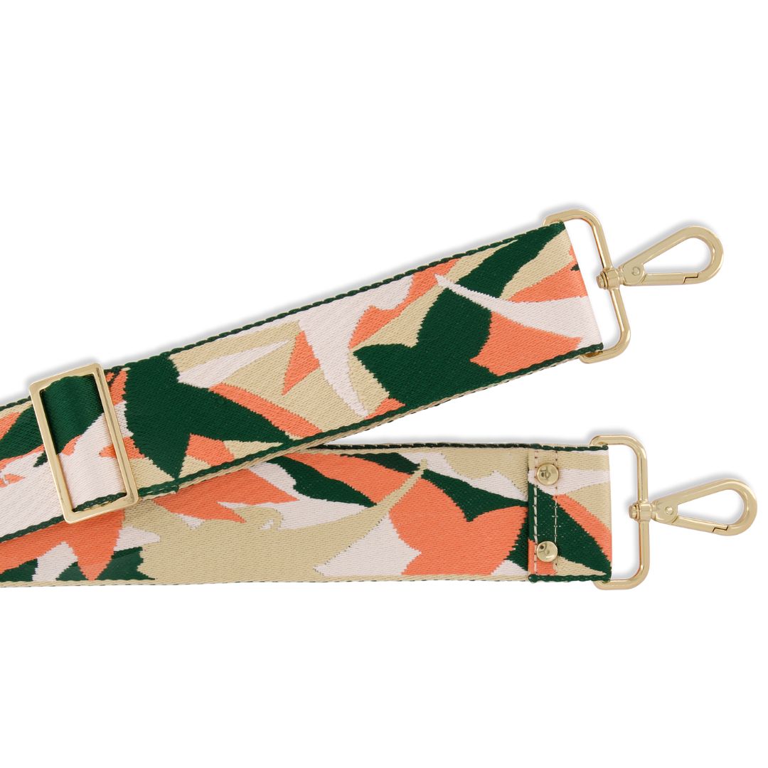 Floral patterned strap with gold hardware on a white background