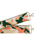 Floral patterned strap with gold hardware on a white background