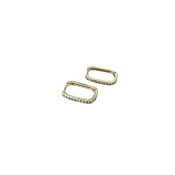 Gold hoop earrings on a textured surface with a gold frame.