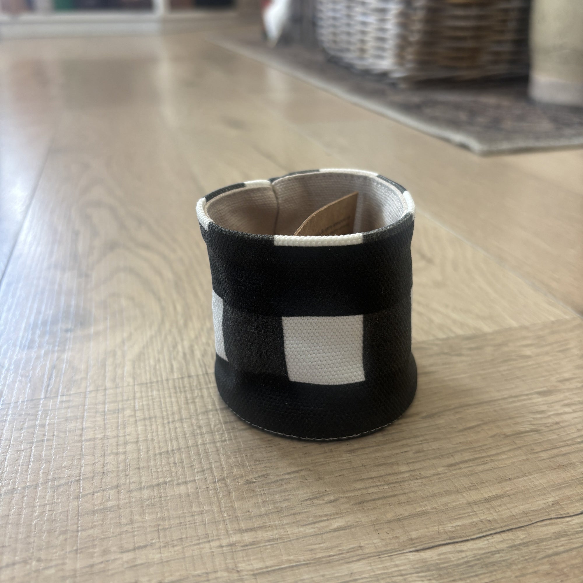 Black and white checkered object on a wooden floor