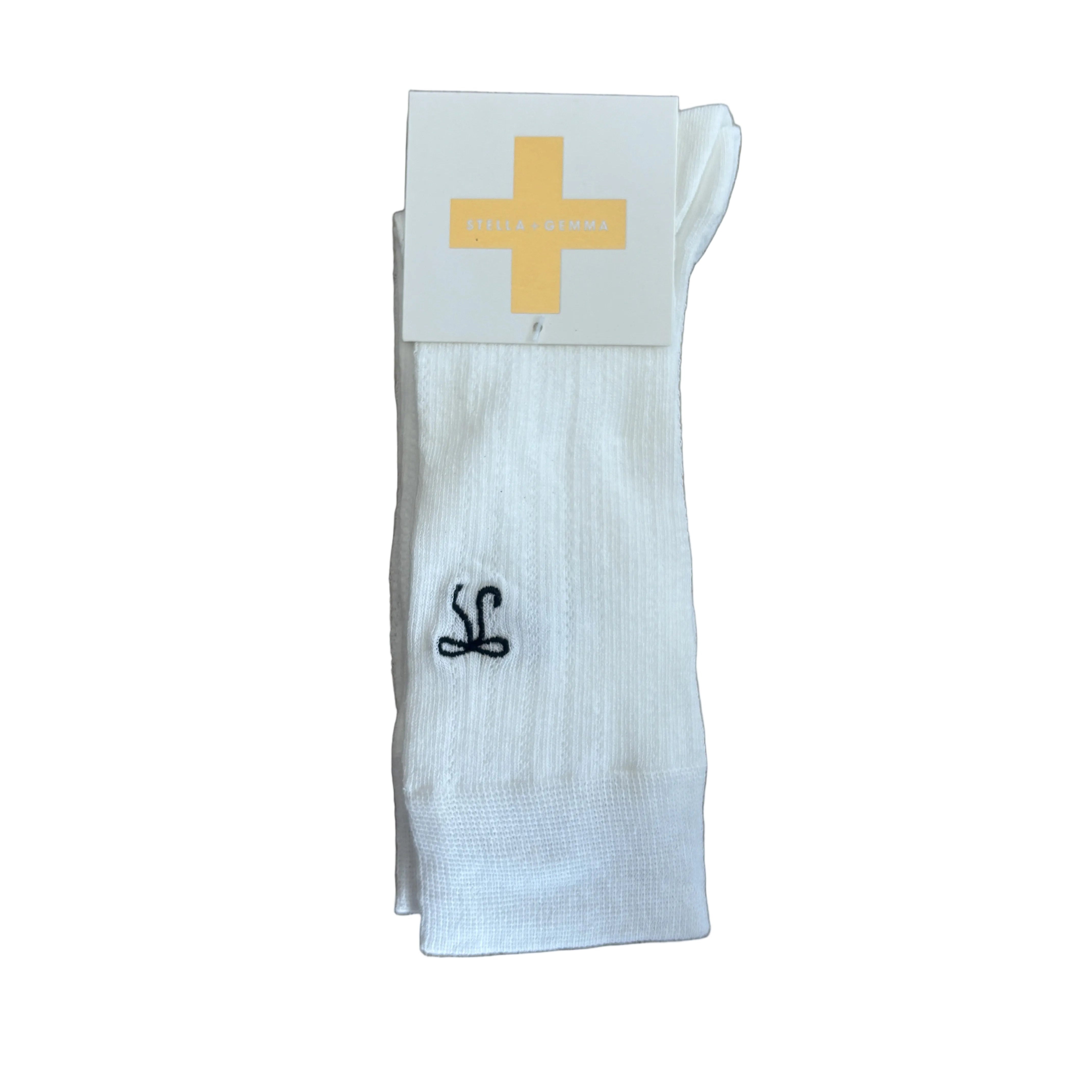 White sock with black logo on a wooden surface