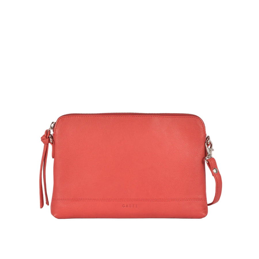 Red handbag with a strap on a light gray background