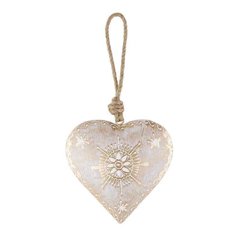 Decorative heart-shaped ornament with gold patterns on a white background