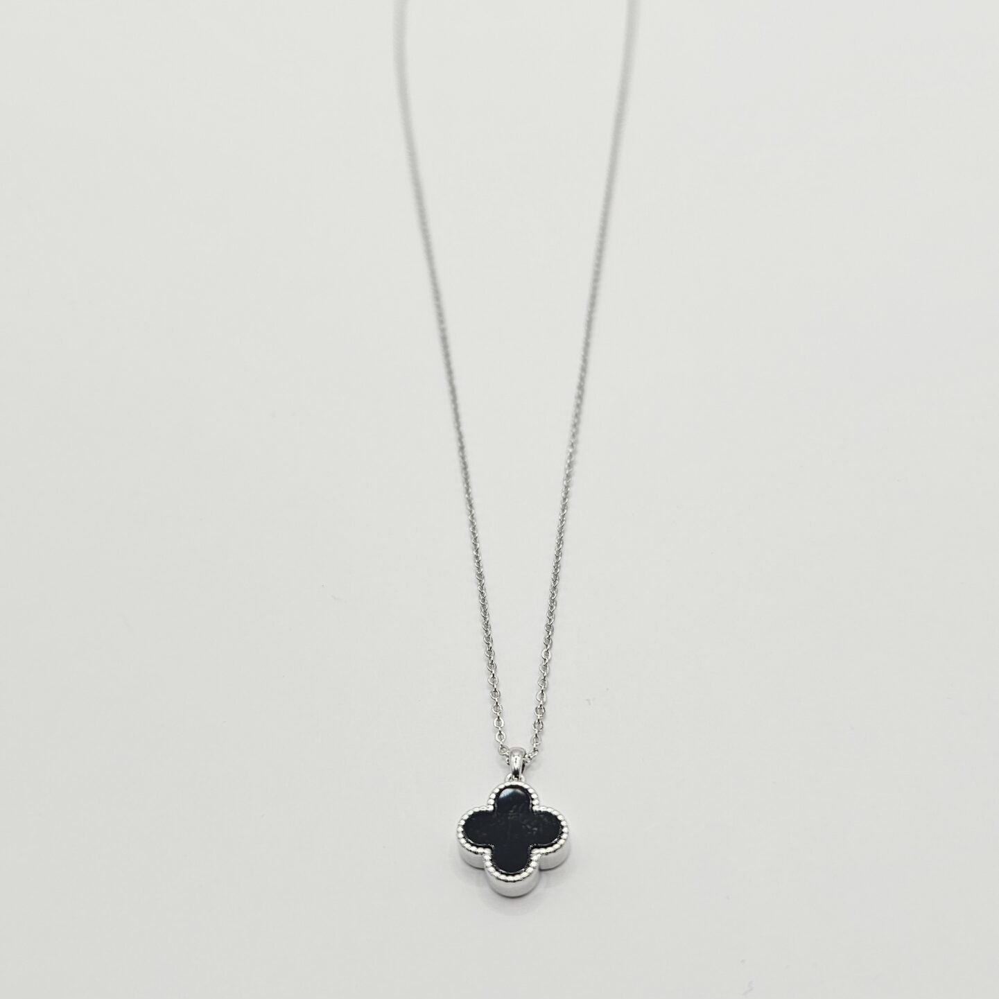 Necklace with a clover-shaped pendant on a white background