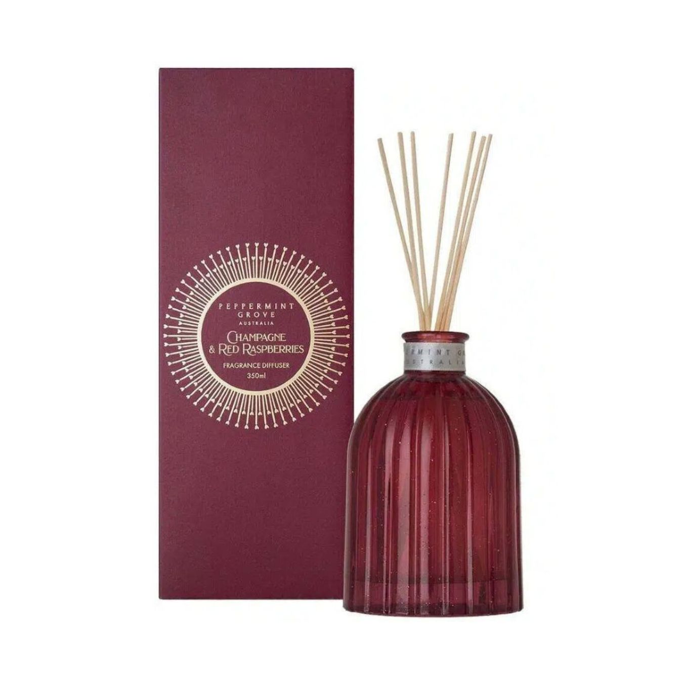 Red diffuser bottle with reeds and packaging on a white background