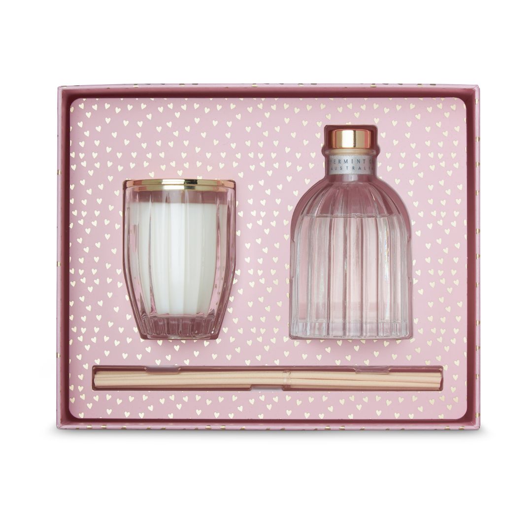 Set of pink glass candle and bottle with gold accents in a polka dot box