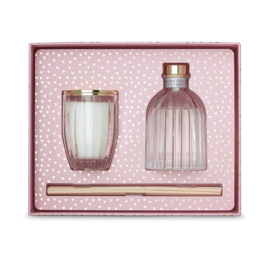 Set of pink glass candle and bottle with gold accents in a polka dot box