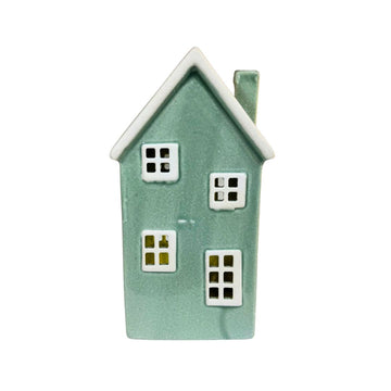 Small green ceramic house with white windows on a white background