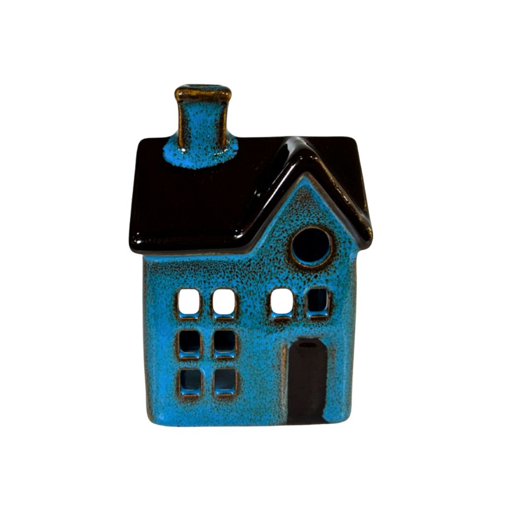 Ceramic house-shaped teal and black object on a white background