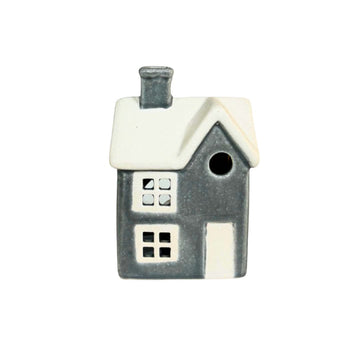 Small ceramic house-shaped birdhouse on a white background