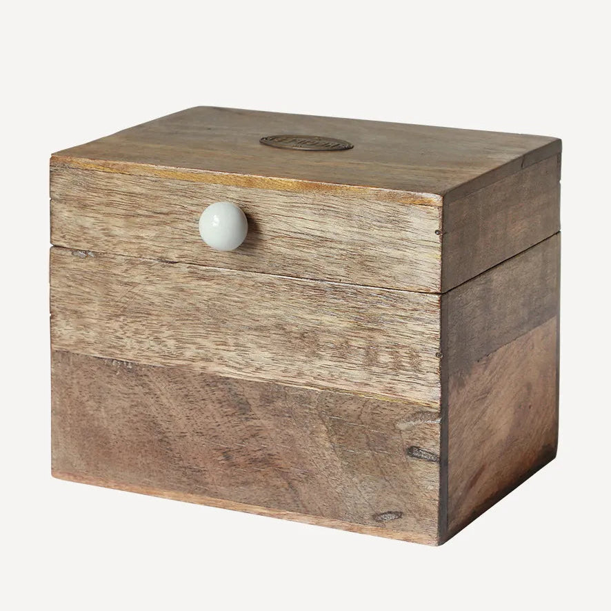 Wooden box with a white knob on a white background