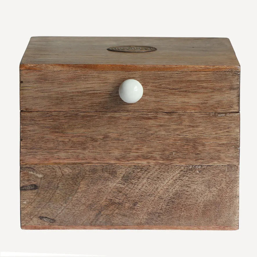 Wooden box with a white knob on a light gray background