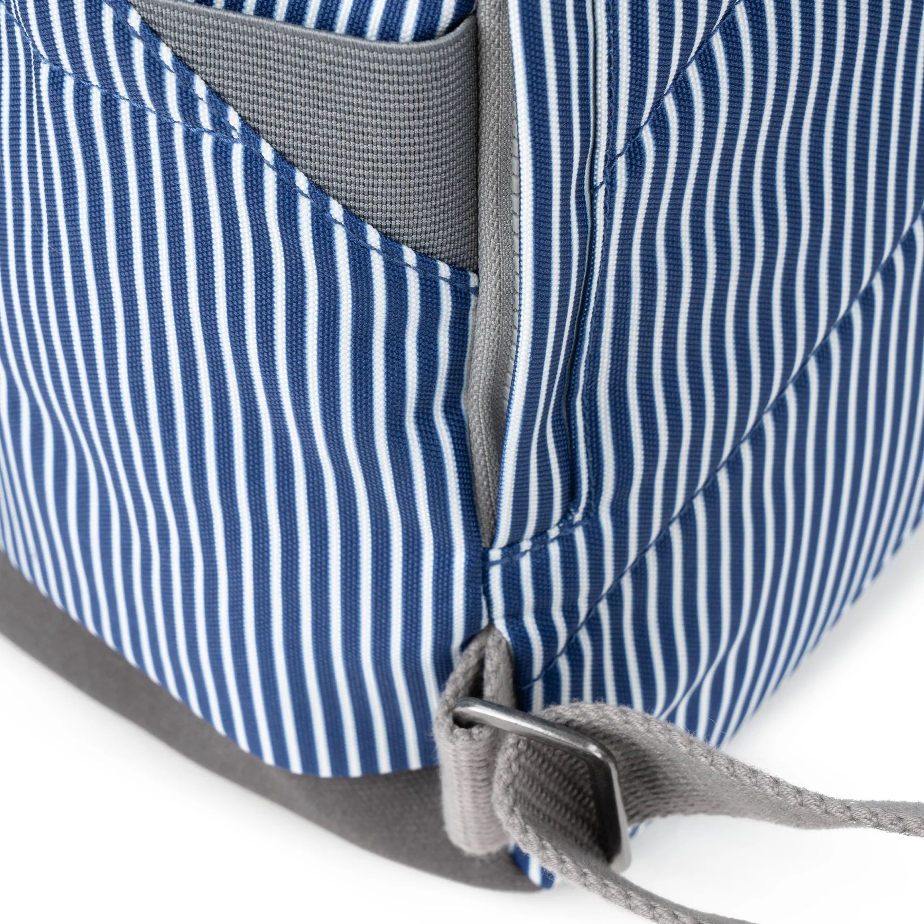 Close-up of a blue and white striped bag with gray straps on a white background