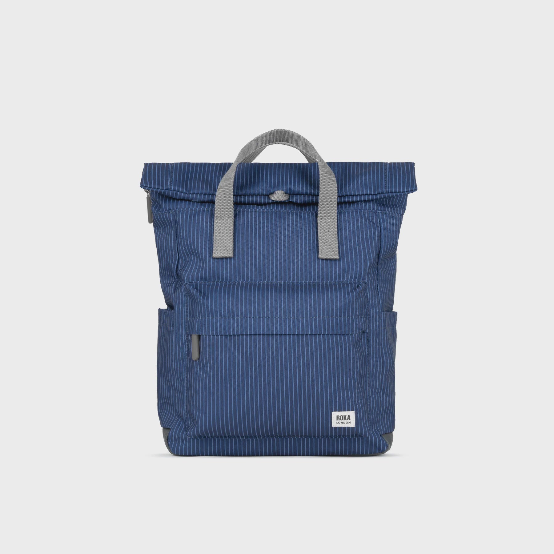 Blue backpack with gray handle on a light gray background