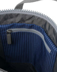 Close-up of a blue zipper pocket on a gray bag