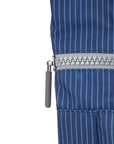 Close-up of a blue pinstripe garment with a zipper on a white background