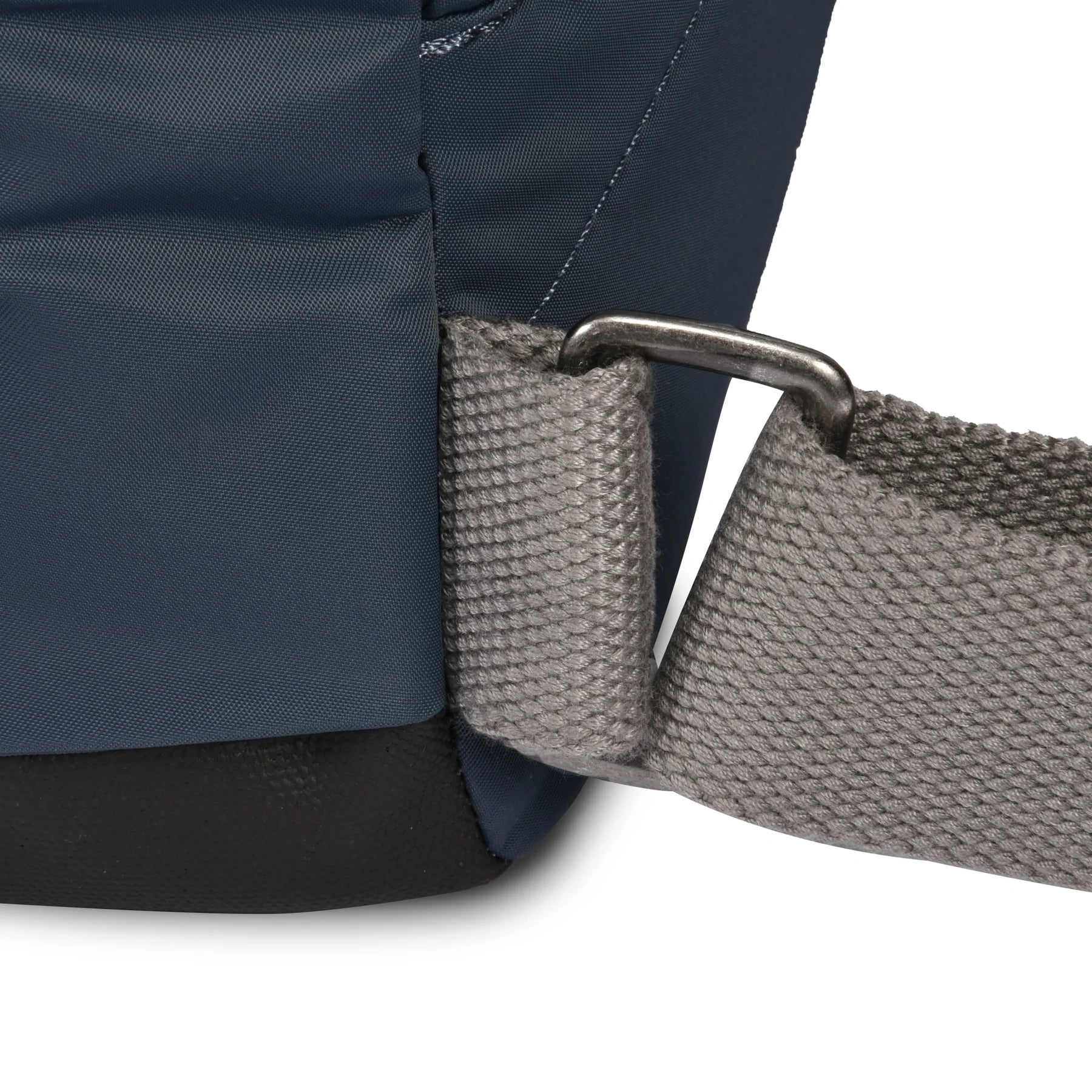 Close-up of a blue backpack with a gray strap on a white background