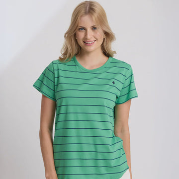 Woman wearing a green striped shirt with a small logo on a white background