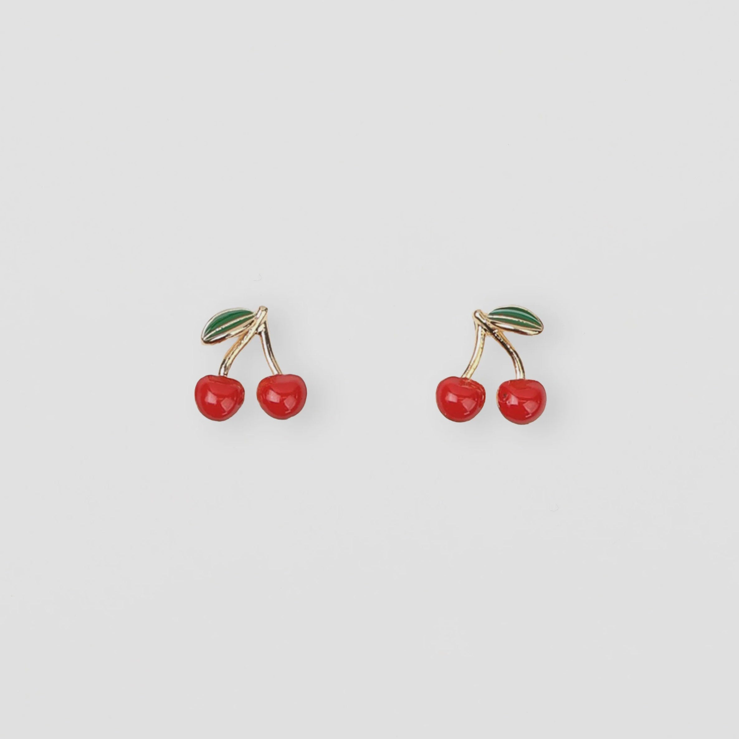 Cherry-themed earrings on a light gray background