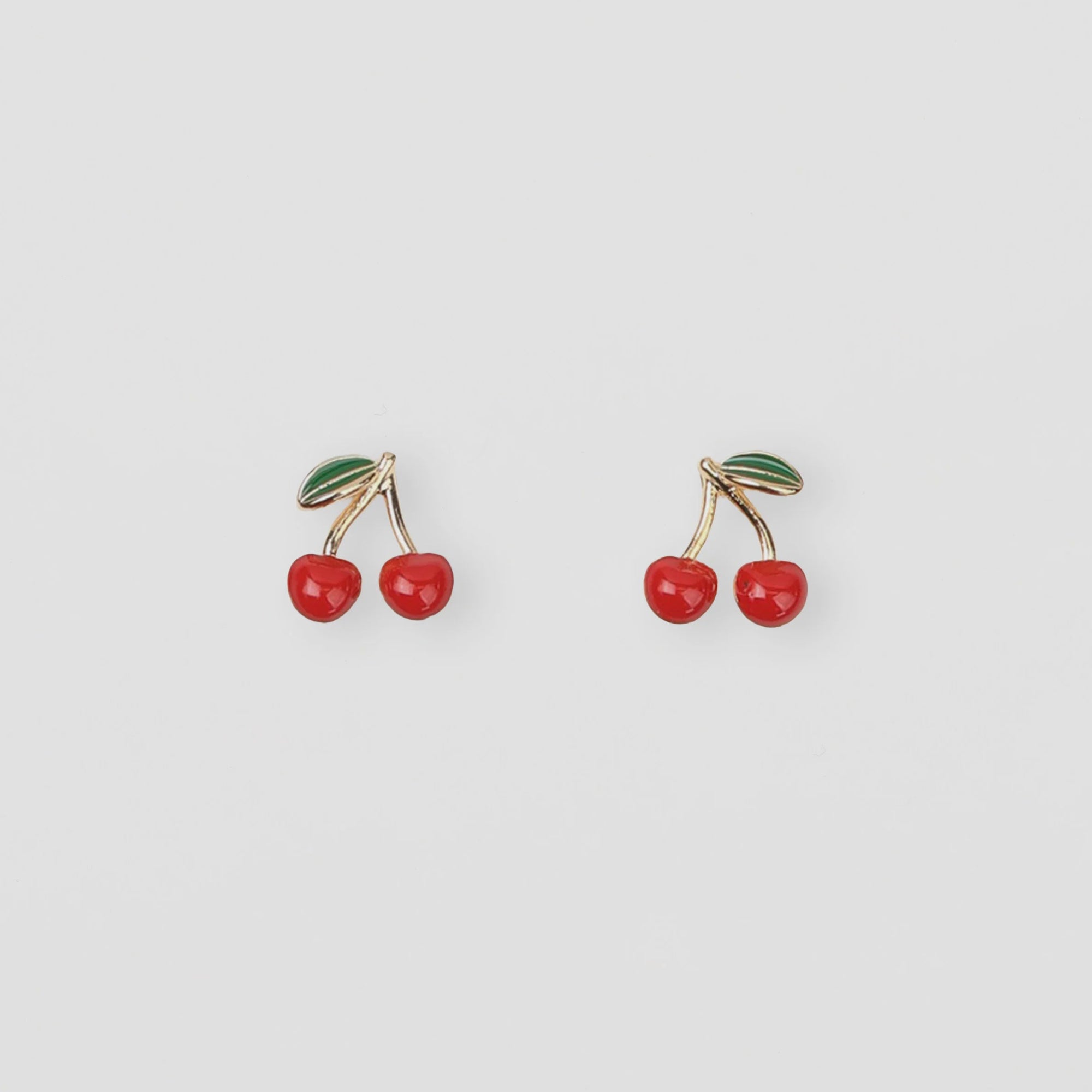 Cherry-themed earrings on a light gray background