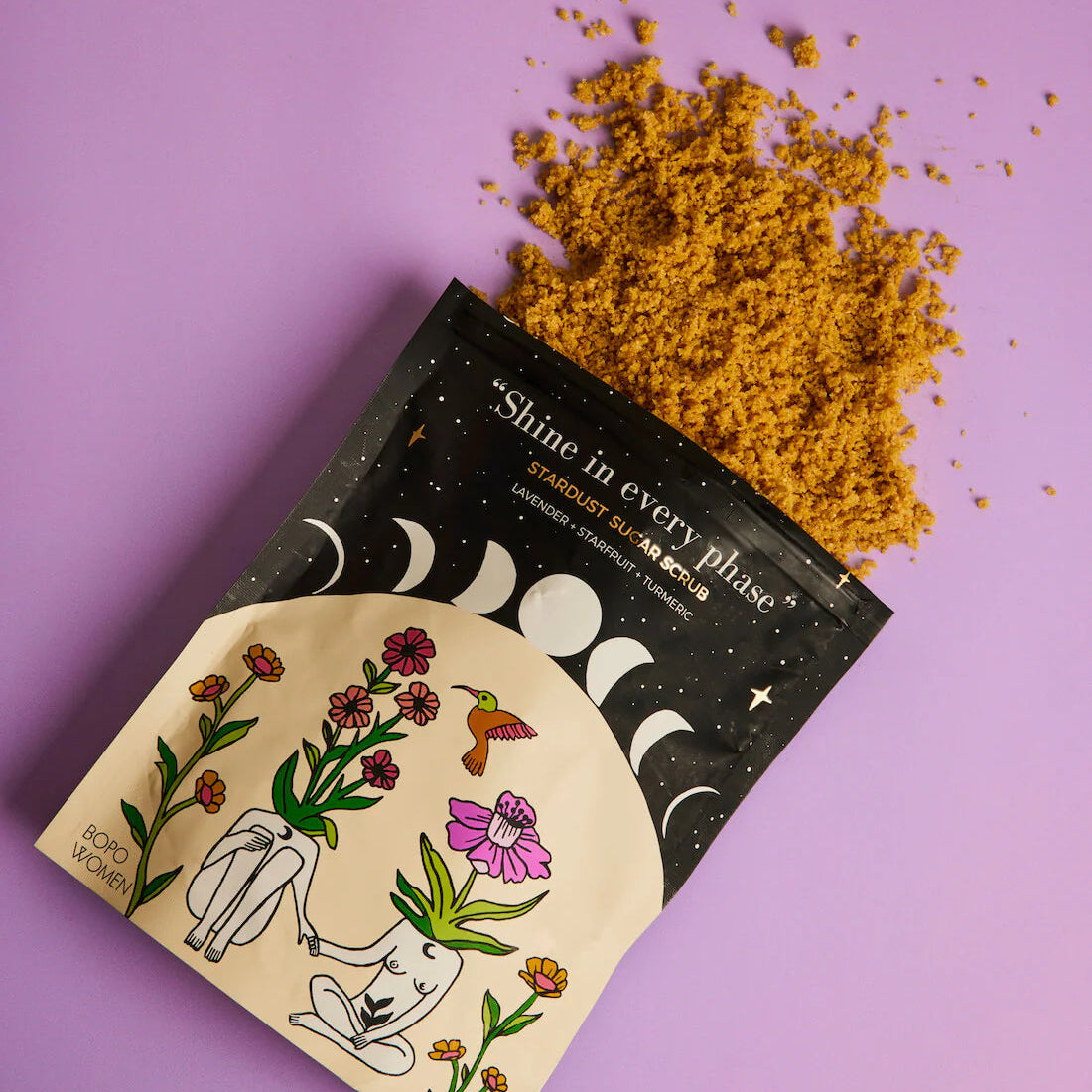 Star dust sugar scrub packaging with yellow powder on a purple background
