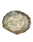 Decorative gold shell on a wooden floor