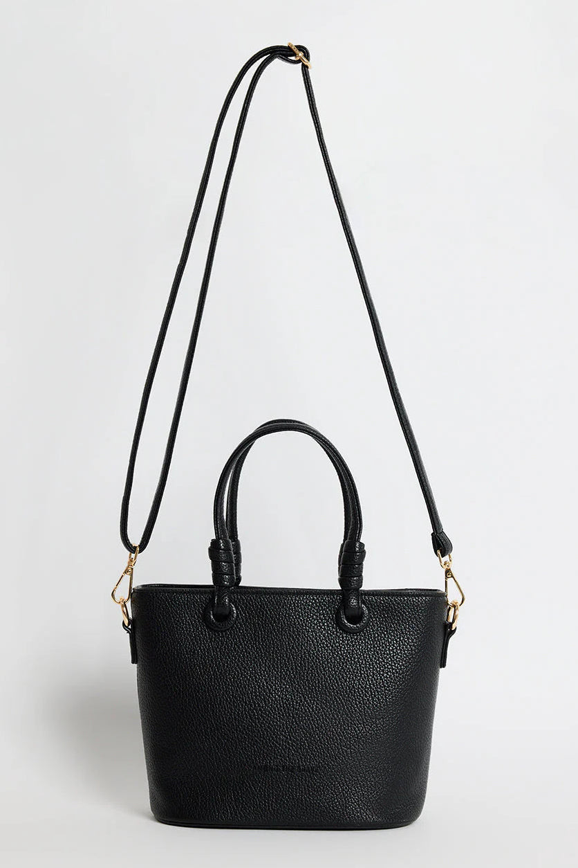Black handbag with a strap on a white background