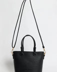 Black handbag with a strap on a white background