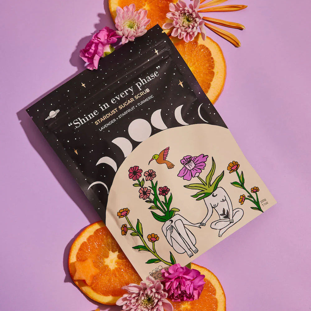 Product packaging with floral design and oranges on a purple background