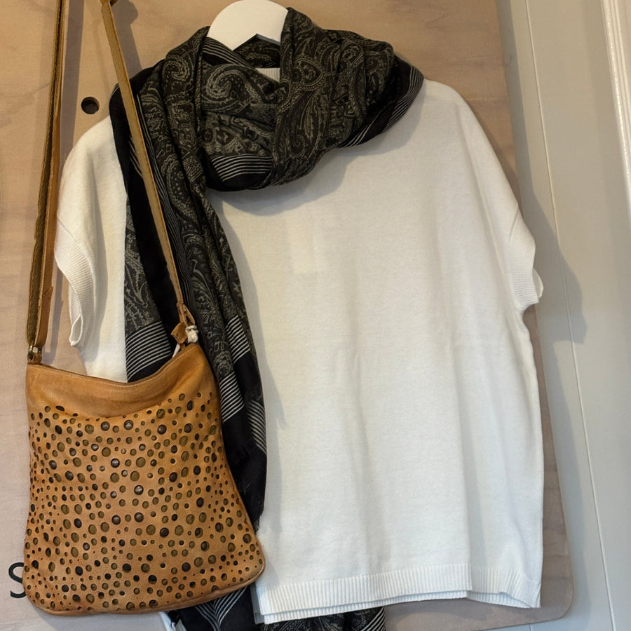 Handbag with a leopard print pattern on a wooden surface