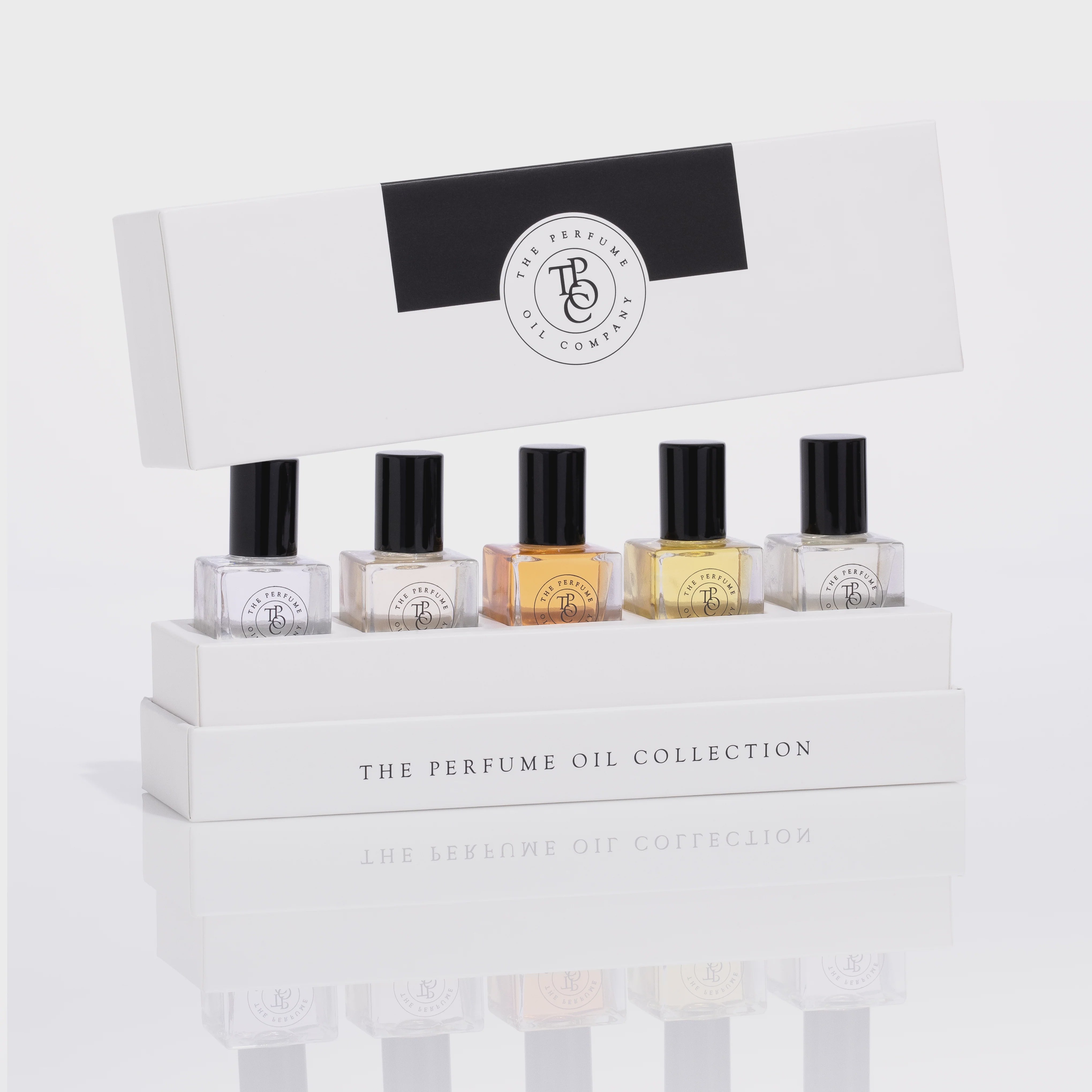 Set of perfume bottles in a display box with 'The Perfume Oil Company' branding.