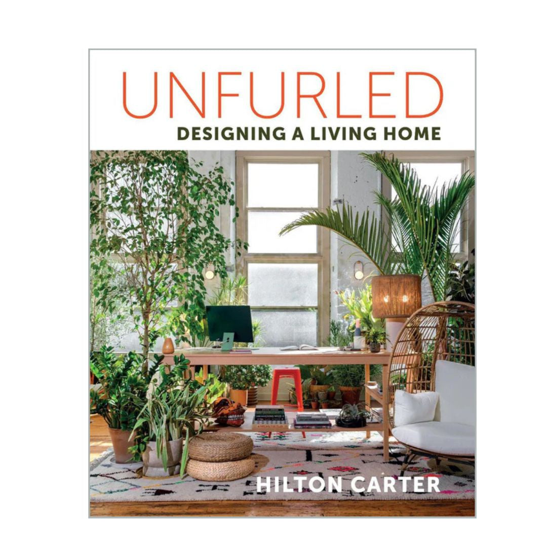 Book cover of 'Unfurled: Designing a Living Home' by Hilton Carter with a modern living room design.