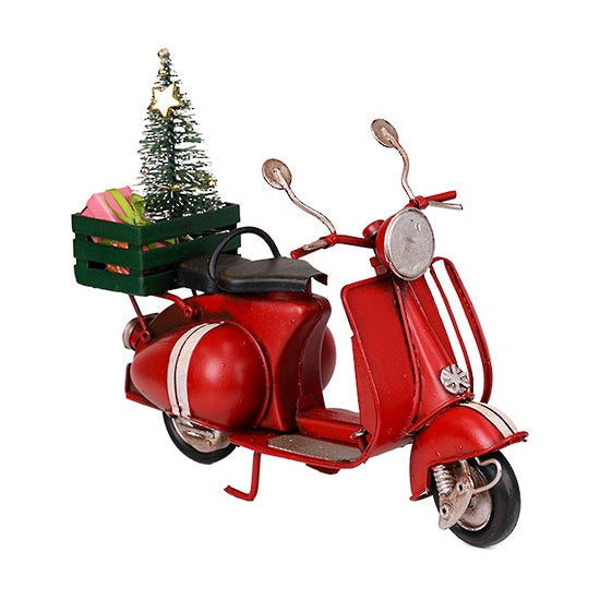 A decorative metal vintage scooter in red color with a Christmas tree and presents on the back rack.