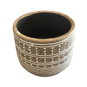 Ceramic pot with decorative patterns on a wooden surface