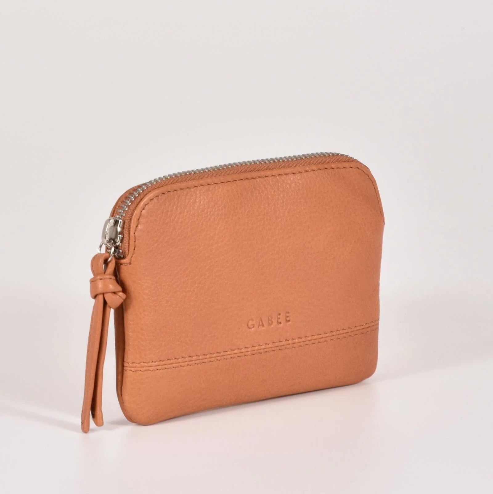 Brown leather wallet with a strap on a light gray background