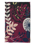 Floral patterned scarf with leaves and a dandelion design on a dark background