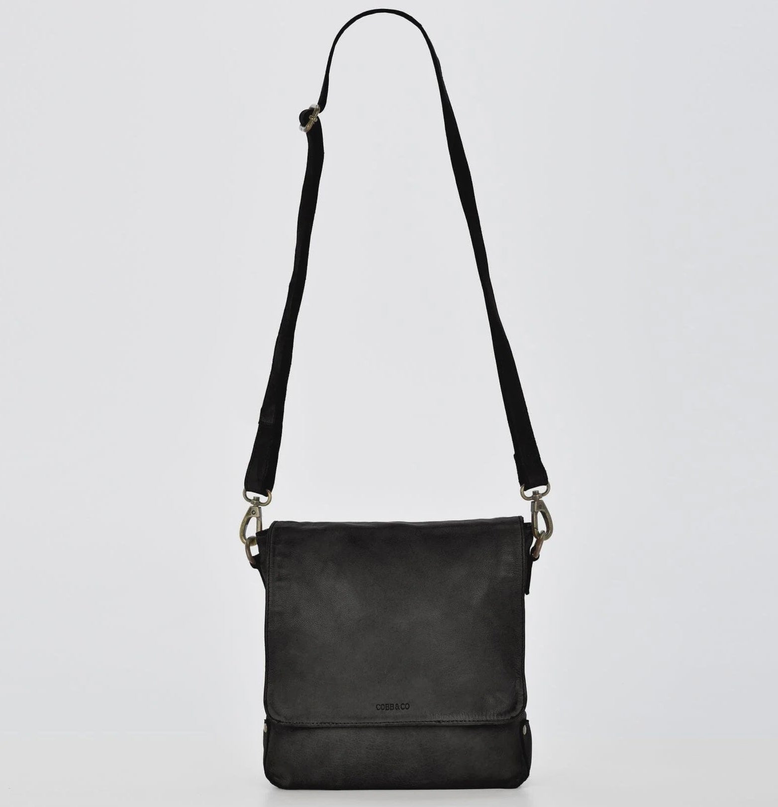 Black leather crossbody bag on a light gray background