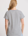 Woman wearing a black and white striped t-shirt on a plain background
