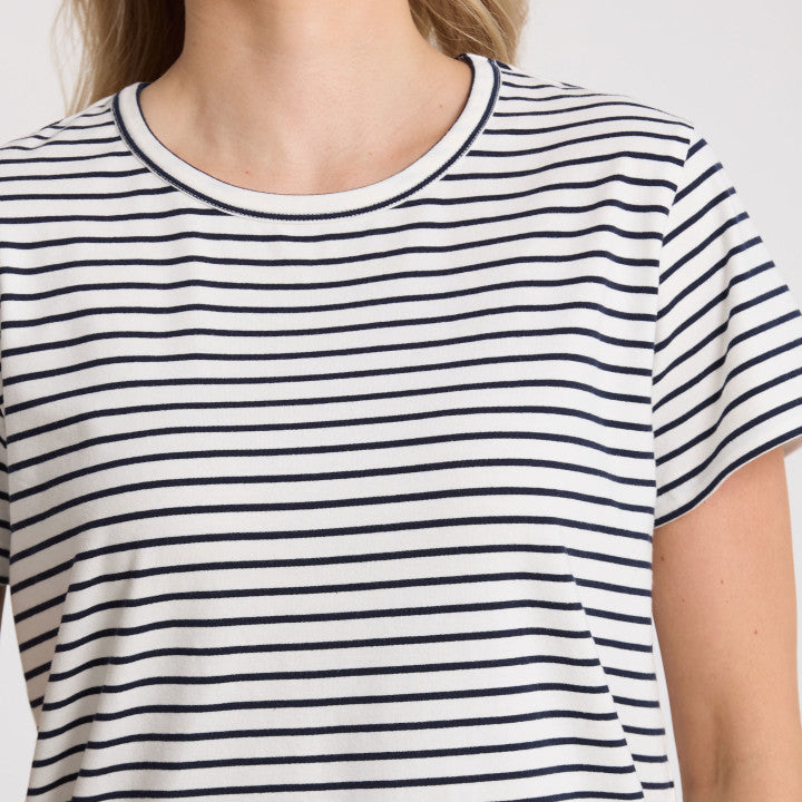 Person wearing a black and white striped t-shirt on a plain background