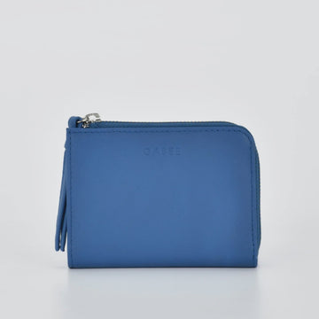 Blue wallet with a visible brand logo on a light gray background