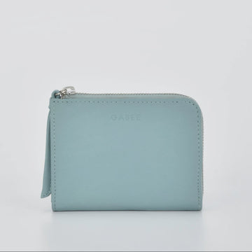 Light blue wallet with a zipper on a light gray background