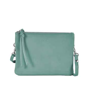 Green leather crossbody bag on a light gray background