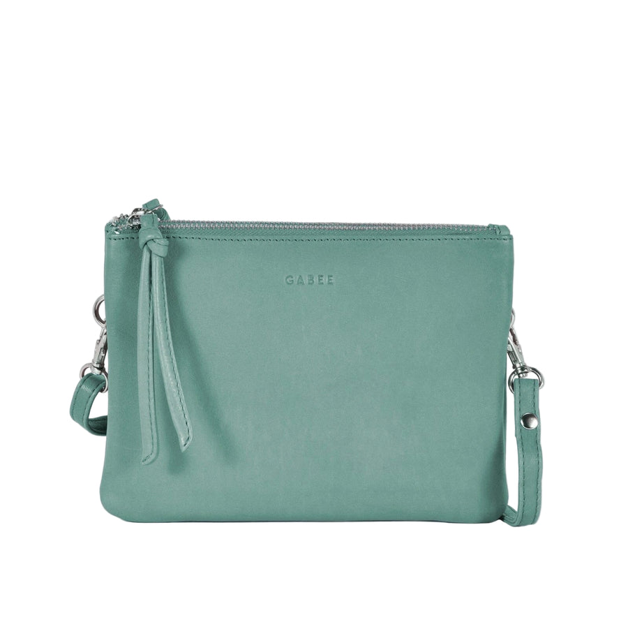 Green leather crossbody bag on a light gray background