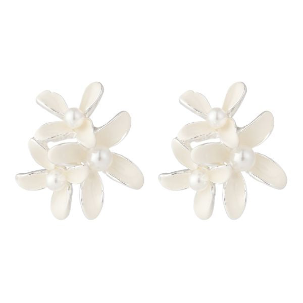Pair of white flower-shaped earrings with pearl centers on a white background