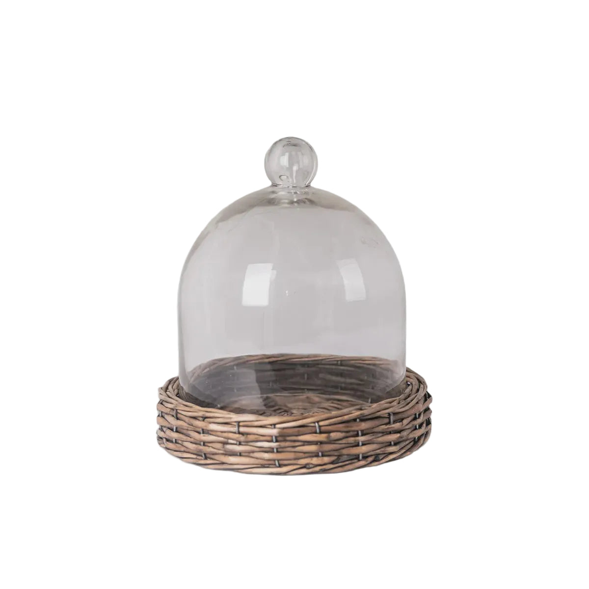 Glass cloche on a wicker stand against a light gray background