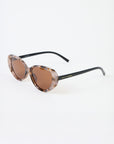 Sunglasses with tortoiseshell frame and brown lenses on a white background