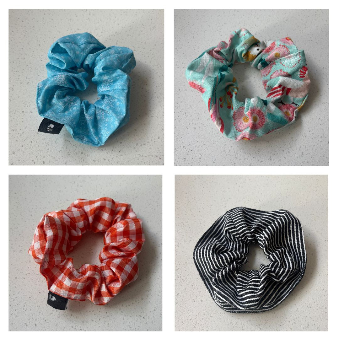 Four scrunchies in different patterns on a light gray background