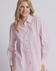 Woman wearing a pink striped shirt against a plain background
