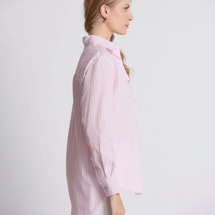 Woman wearing a pink and white striped shirt on a light gray background