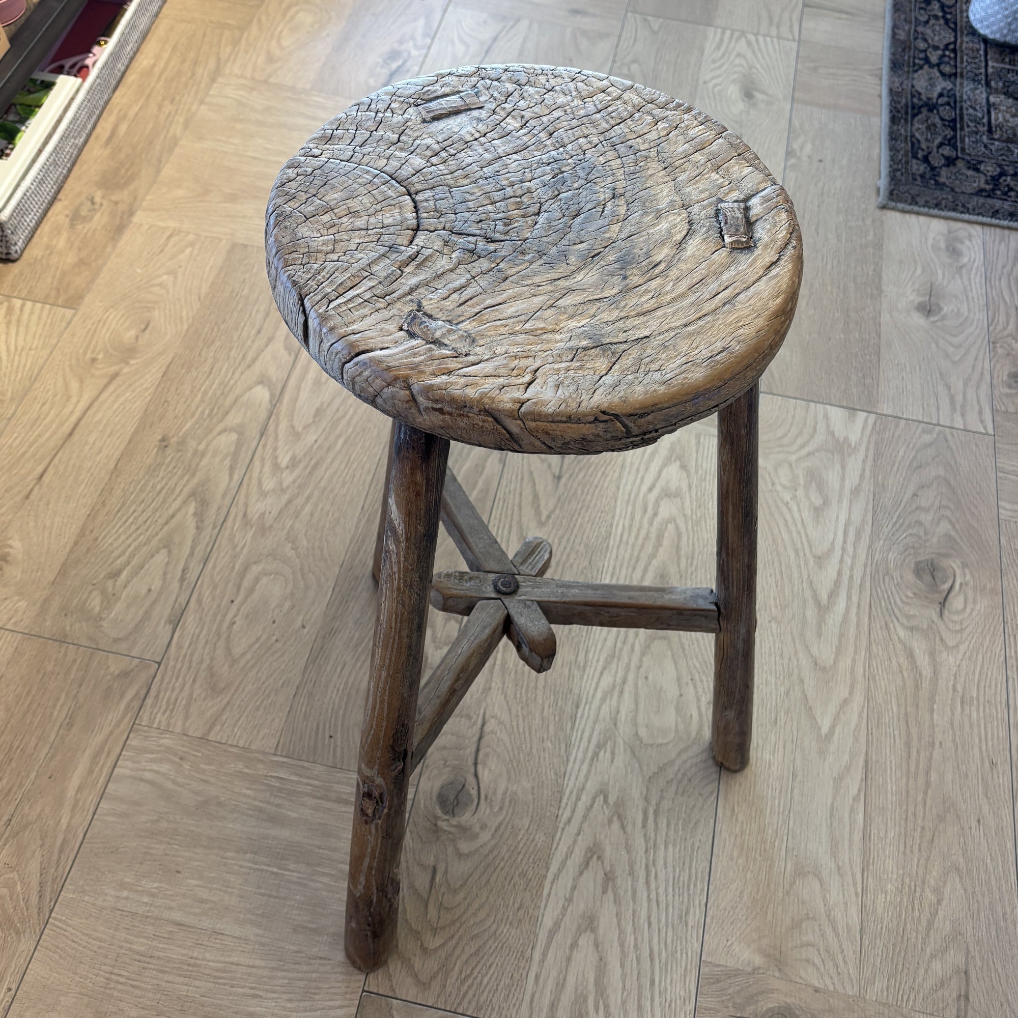 Vintage wooden stool on a wooden floor